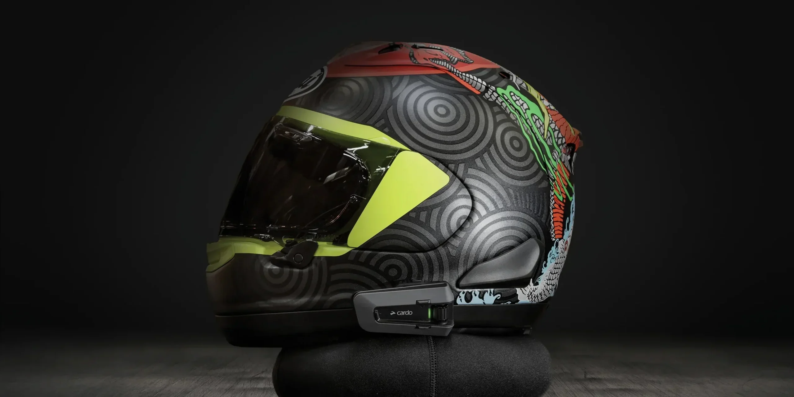 Studio Shot of Cardo Packtalk Edge installed on colorful helmet