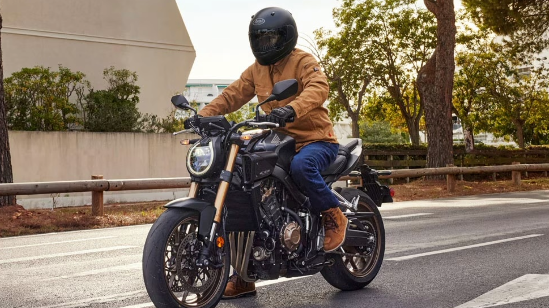 Motorcyclist in riding gear inspecting bike before spring ride in Richmond VA