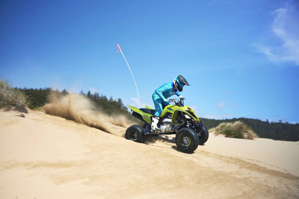 Yamaha Raptor 700 driven over sand dunes.