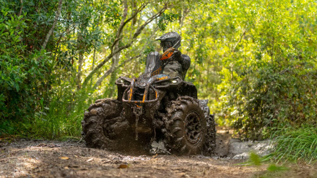 Can-Am Renegade XMR 1000r Sport ATV being ridden through mud.