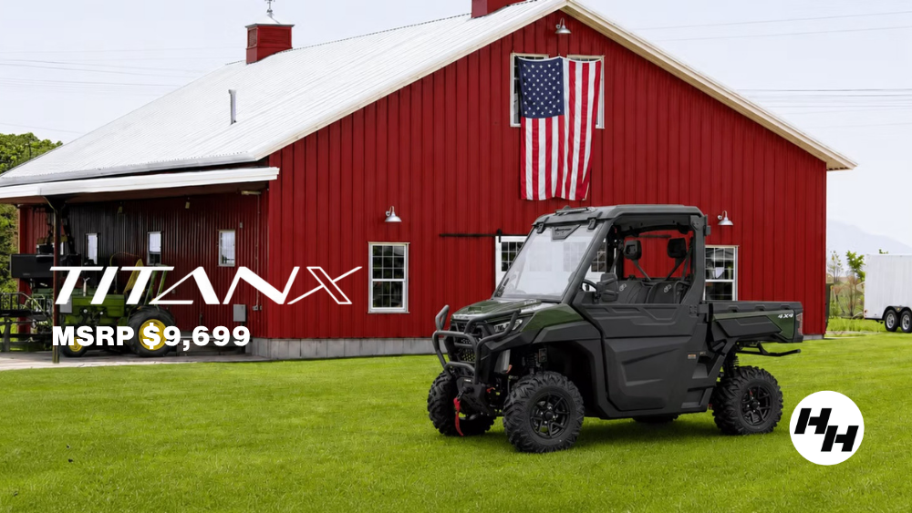 Titan X model parked in front of a red barn on a farm.