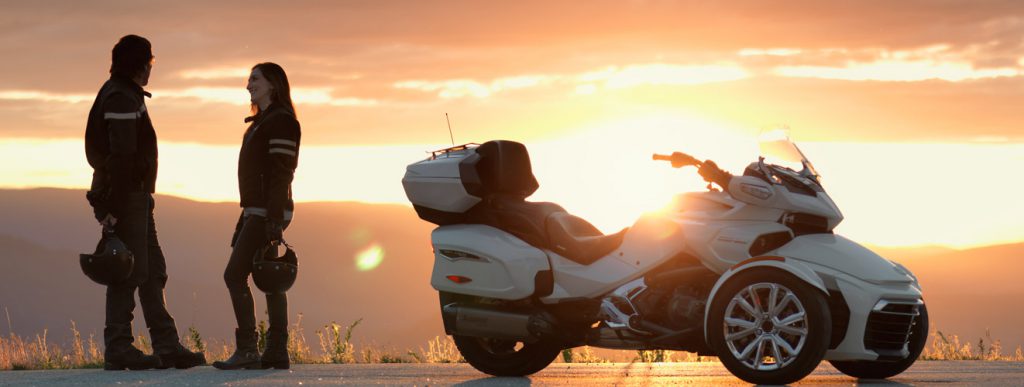 two riders checking out the sunset in front of their Can-Am Spyder