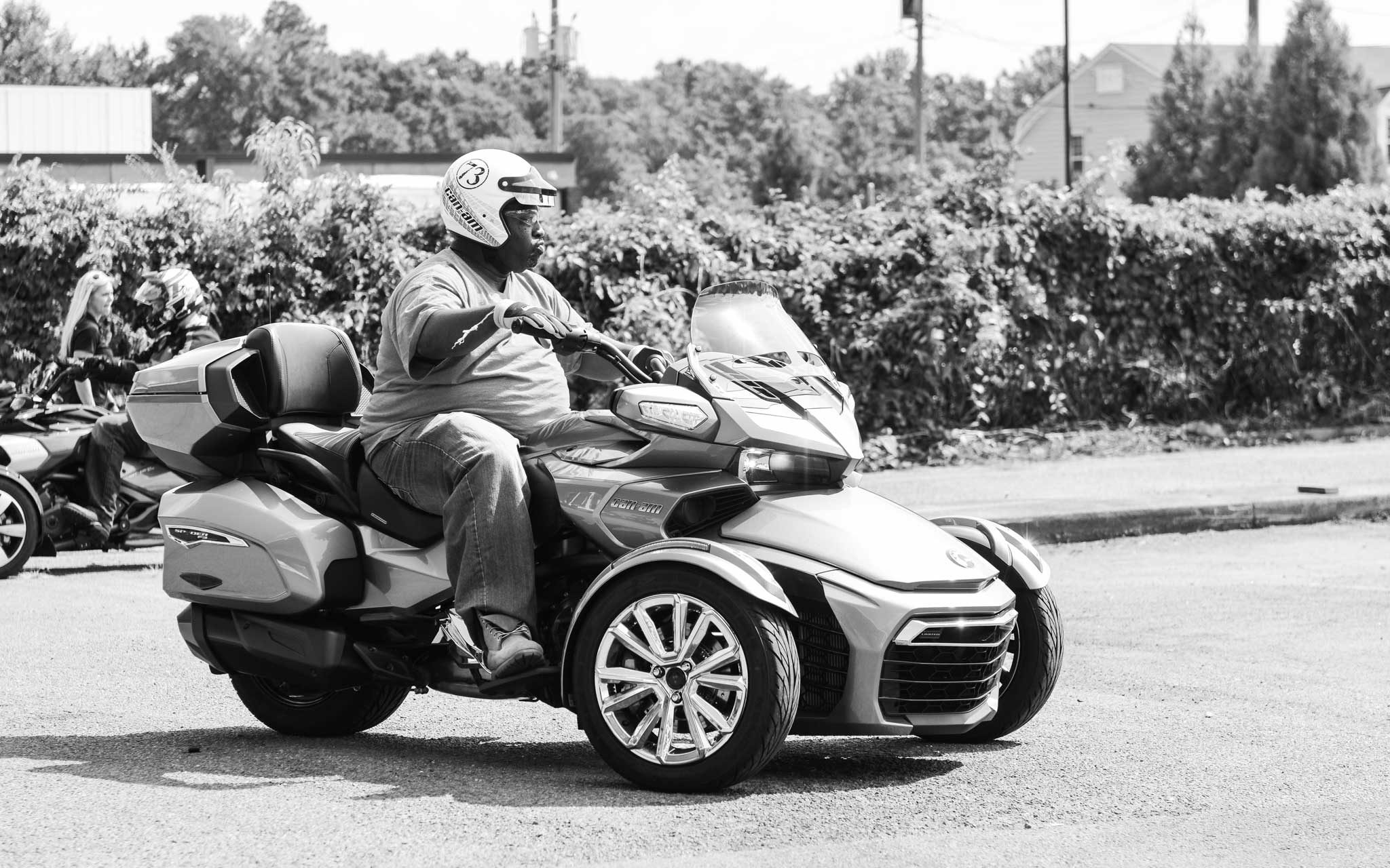 black and white photo of customer test-riding Can-Am Spyder at event