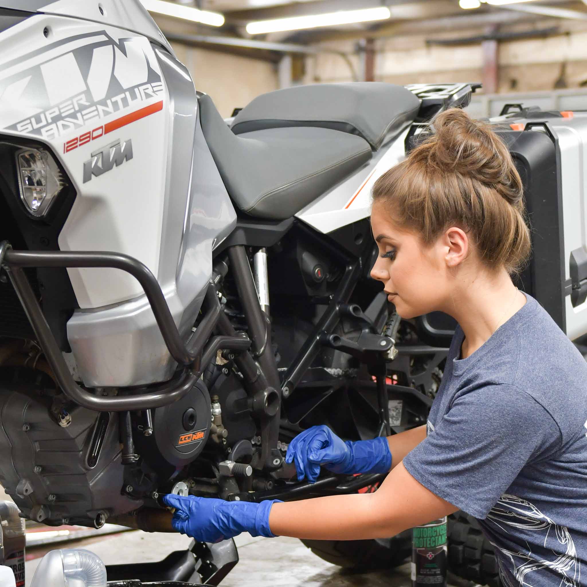 service tech working on customer's motorcycle