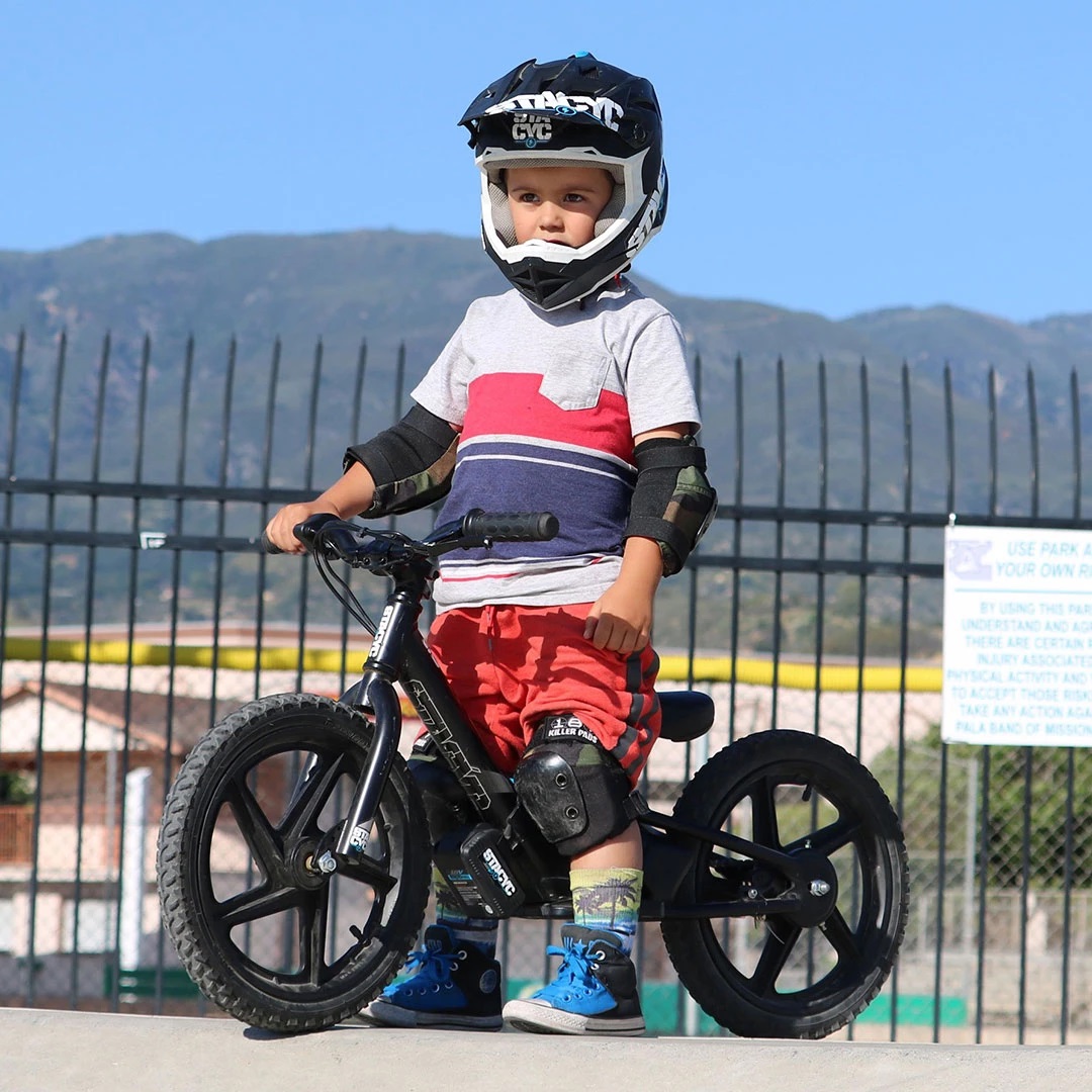 Kid waiting turn at skatepark on Stacyc 16