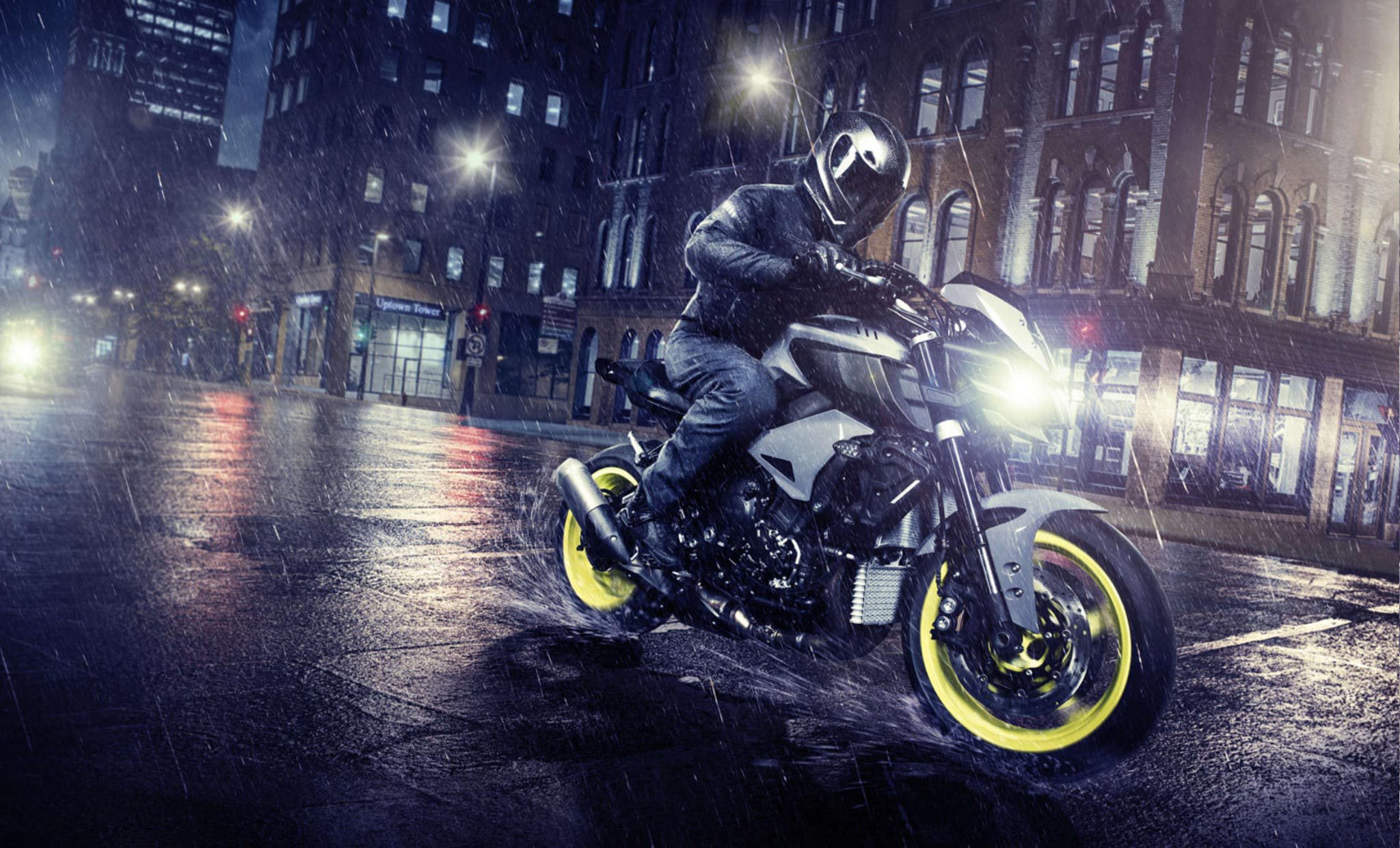 Motorcycle rider through the city in the night rain