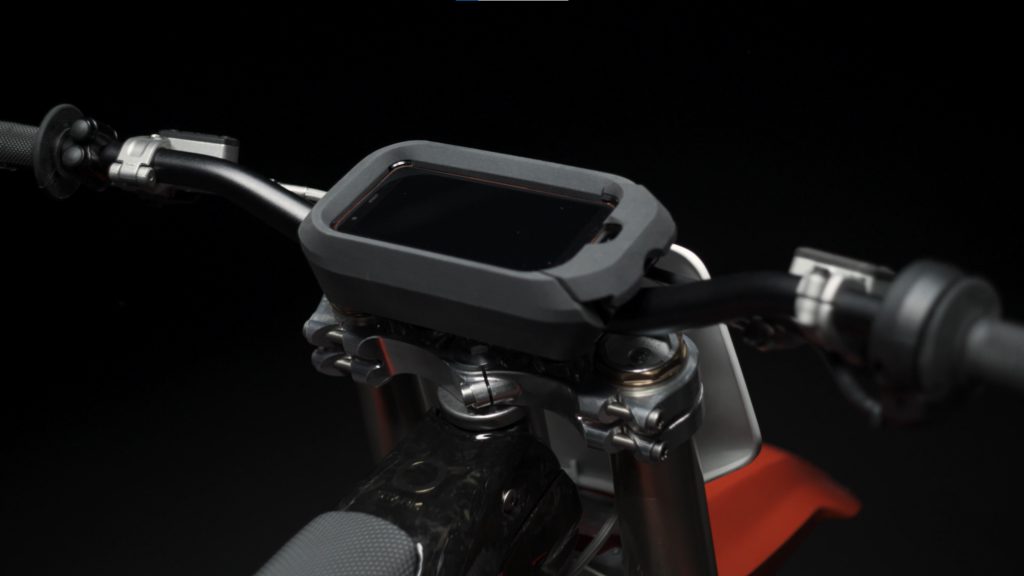 Close up of heads-up display on handlebars of red Stark Varg dirt bike