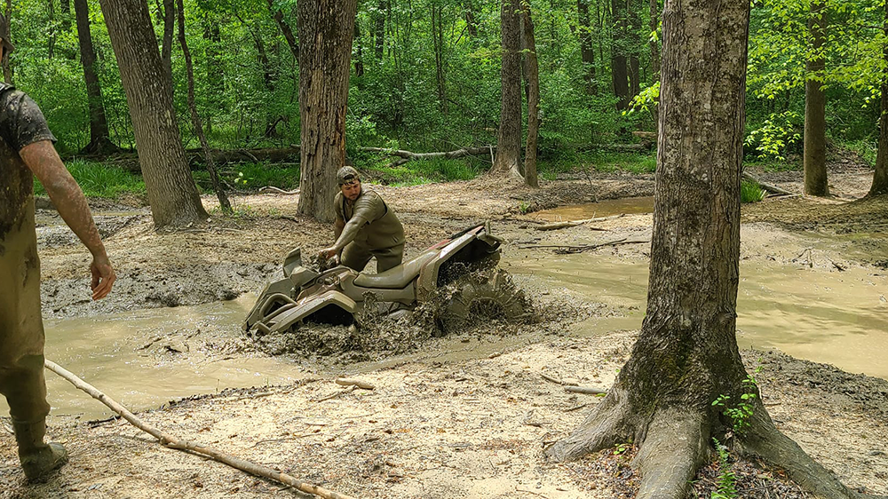 atv rider working bike out of mud pit at red oak hollow atv trails via facebook page