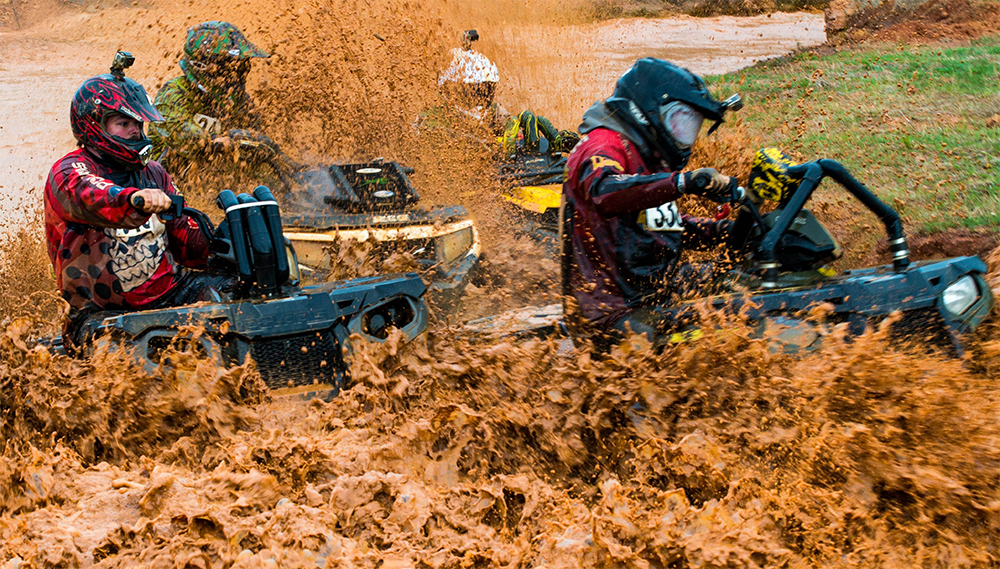 group of atv riders going through mud bog at busco beach via website